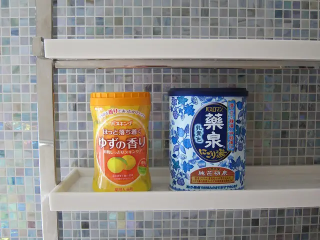 Yuzu bath salts in containers placed on a bathroom shelf