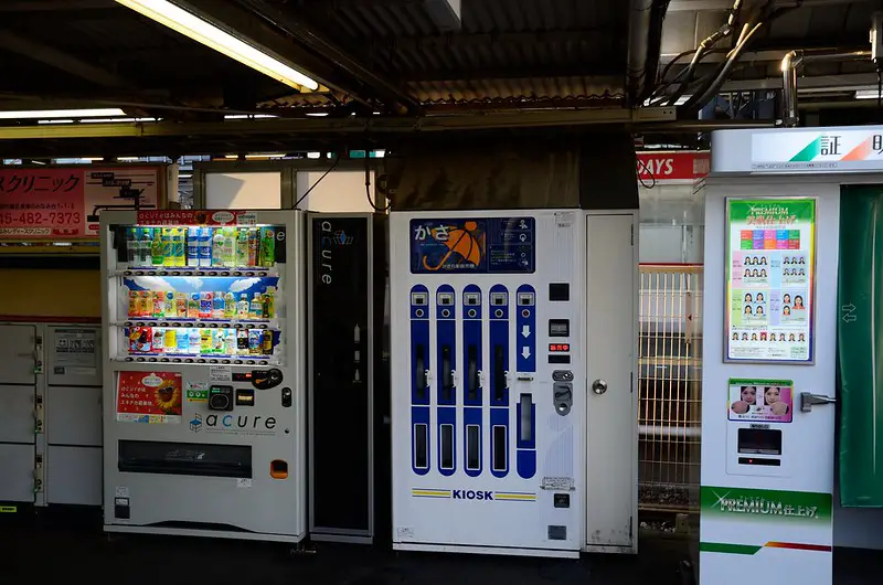 An Umbrella Vending Machine wedged between two other vending machines