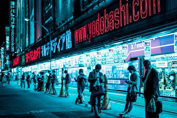 People walking outside Yodobashi Camera store in Tokyo