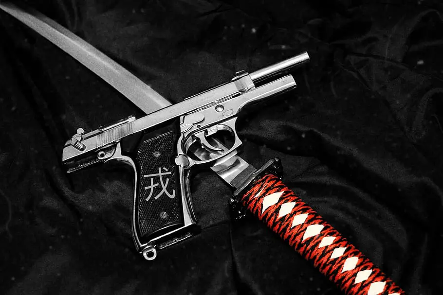A handgun and a katana.